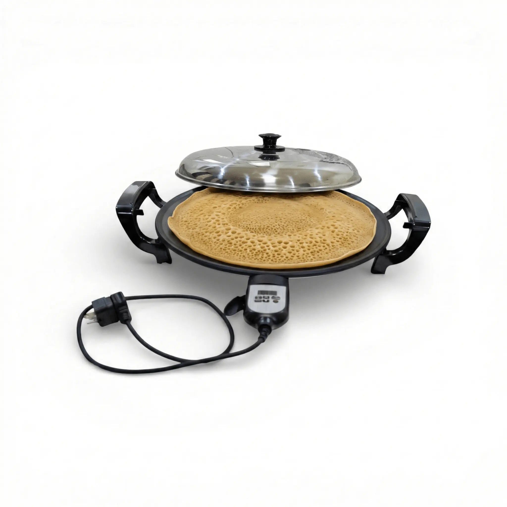 Electric griddle with a pancake on a white background